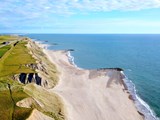 aerial view of Bovbjerg Fyr lighthouse, cliffs and North Sea in Denmark